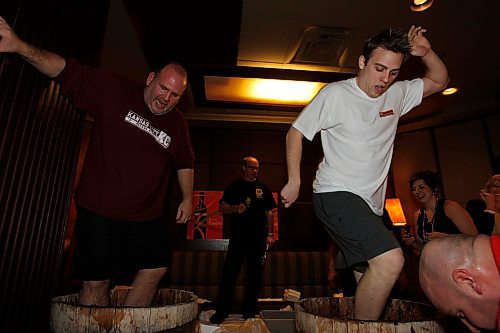 BORIS MINKEVICH / WINNIPEG FREE PRESS  080430 Winnipeg Free Press sports writer Gary Lawless and Troy Scott from Hank 107.7 FM do some grape stomping at the Blaze Bistro in the Delta Hotel. It was a fundraider for special olympics.