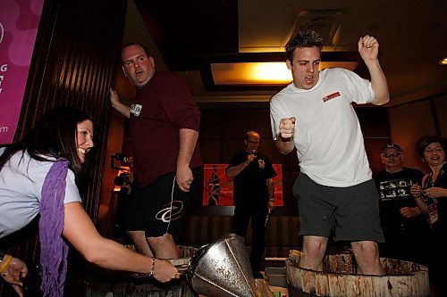 BORIS MINKEVICH / WINNIPEG FREE PRESS  080430 Billie Jo 102.3 clear FM , Winnipeg Free Press sports writer Gary Lawless, and Troy Scott from Hank 107.7 FM do some grape stomping at the Blaze Bistro in the Delta Hotel. It was a fundraider for special olympics.