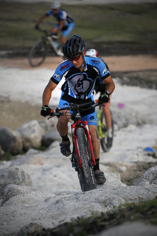 JOHN WOODS / WINNIPEG FREE PRESS Alex Man, assistant coach and course designer for the Manitoba Cycling mountain bike team, makes his way up a hill as the team practices at Bison Butte, a new racing venue in Winnipeg, Tuesday, August 9, 2016.
