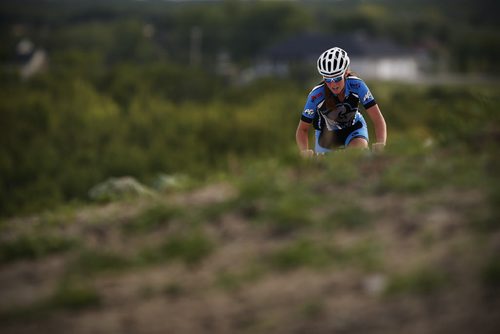 JOHN WOODS / WINNIPEG FREE PRESS , assistant coach of the Manitoba Cycling mountain bike team, makes her way up a hill as the team practices at Bison Butte, a new racing venue in Winnipeg, Tuesday, August 9, 2016.