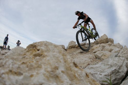 JOHN WOODS / WINNIPEG FREE PRESS Mitch Ketler of the Manitoba Cycling mountain bike team goes over an obstacle as the team practices at Bison Butte, a new racing venue in Winnipeg, Tuesday, August 9, 2016.