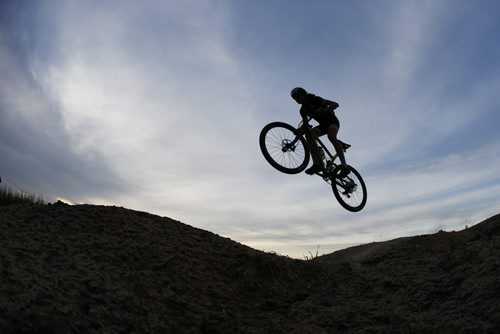 JOHN WOODS / WINNIPEG FREE PRESS Mitch Ketler of the Manitoba Cycling mountain bike team catches air on an obstacle as the team practices at Bison Butte, a new racing venue in Winnipeg, Tuesday, August 9, 2016.