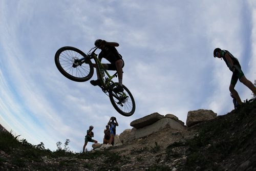 JOHN WOODS / WINNIPEG FREE PRESS Mitch Ketler of the Manitoba Cycling mountain bike team catches air on The Horn as the team practices at Bison Butte, a new racing venue in Winnipeg, Tuesday, August 9, 2016.