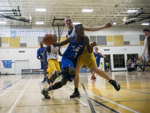 ZACHARY PRONG / WINNIPEG FREE PRESS  Ivan Mugisha, number 7, of the Winnipeg Blue rushes the net during the Manitoba Summer Games Male Basketball final on August 10, 2016. The Winnipeg Gold eventually came out on top with a 82-75 win.