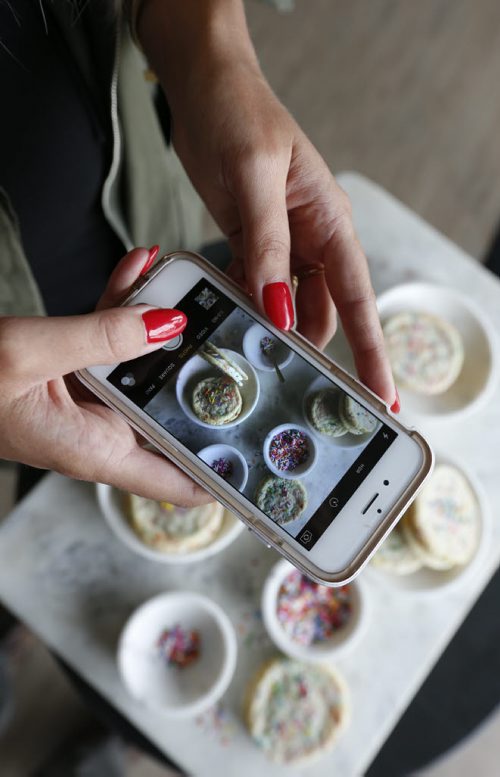 WAYNE GLOWACKI / WINNIPEG FREE PRESS   Jenna Rae Cakes, a hot local bakery run by twin sisters Jenna and Ashley Illchuk use Instagram to promote their business.  Ashley is taking a photo of their cookie sandwiches. Jen Zoratti   story  August 10 2016