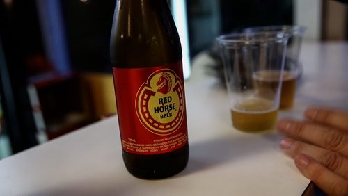 MIKE DEAL / WINNIPEG FREE PRESS Ben MacPhee-Sigurdson takes us on a tour of Folklorama pavilion's to sample various drinks and food. A bottle of Red Horse an 8% philippine beer. 160809 - Tuesday, August 09, 2016