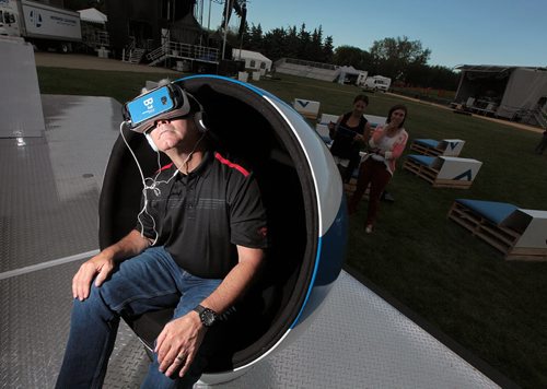 PHIL HOSSACK / WINNIPEG FREE PRESS - Free Press writer Brad Oswald checks out the new Bell "Virtual Reality" station on display at the Shaw stage for the weekend. See his story.  August 11, 2016