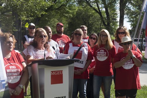 ZACHARY PRONG / WINNIPEG FREE PRESS  Michelle Gawronsky, second from left, the president of the Manitoba Government and General Employees Union (MGEU) surrounded by Macdonald Youth Services (MYS) Crisis Stabilization members and supporters during a rally on August 12, 2016. The MYS Crisis Stabilization members have been on strike for 11 days after more than two years of negotiations over salaries failed.