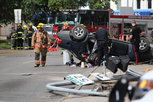 RUTH BONNEVILLE  / WINNIPEG FREE PRESS  A vehicle is seen flipped upside down after appearing to have hit a fire hydrant, light standard and hydro lines to the Balmoral Hotel   closing traffic during rush hour along Balmoral at Cumberland Friday afternoon.    Aug 12 / 2016