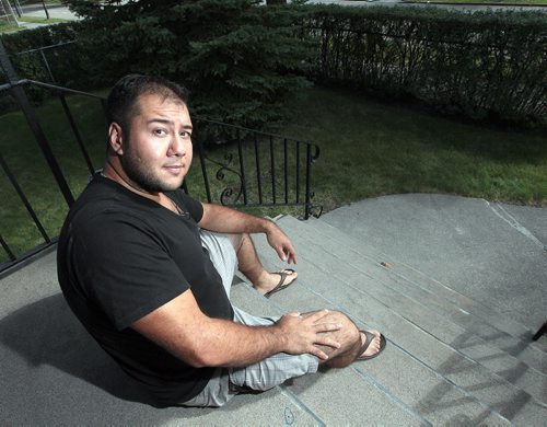 PHIL HOSSACK / WINNIPEG FREE PRESS -  Alain Fourcade, sits on the step of his famly home where hehad to fight off and detain a break and enter suspect yesterday morning for 90 minutes while waiting for police to respond. Now he's charged with assault. Ashley Prest story.  August 12, 2016