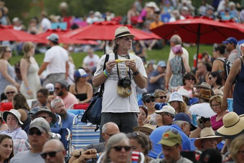 JOHN WOODS / WINNIPEG FREE PRESS A man enjoys some corn on the cob in the midst of music fans at Interstellar Rodeo at the Forks Sunday, August 14, 2016.