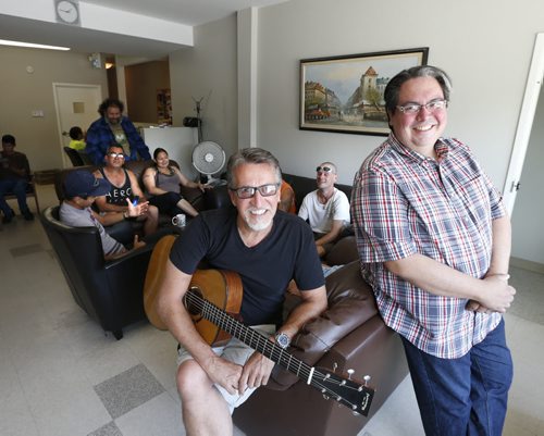 WAYNE GLOWACKI / WINNIPEG FREE PRESS     Faith Page.  At left, singer Steve Bell and Kyle Mason, Executive Director and founder of the North End Family Centre in the community living room of the centre at 1344 Main Street.  They have been attending Sunday services of Manitoba churches this summer to raise money and awareness for ministry.   Brenda Suderman story August 15 2016