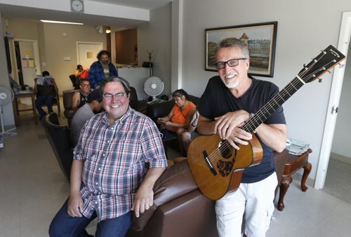 WAYNE GLOWACKI / WINNIPEG FREE PRESS     Faith Page.  At right, singer Steve Bell and Kyle Mason, Executive Director and founder of the North End Family Centre in the community living room of the centre at 1344 Main Street.  They have been attending Sunday services of Manitoba churches this summer to raise money and awareness for ministry.   Brenda Suderman story August 15 2016