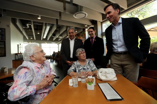 TREVOR HAGAN / WINNIPEG FREE PRESS Dan Vandal, Robert Falcon Ouellette, and Canada's Finance Minister, Honourable Bill Morneau, speaking with Gunvar Larsson and Mary Edwardsson at Stella's on Provencher, Monday, August 15, 2016.
