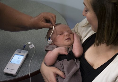 ZACHARY PRONG / WINNIPEG FREE PRESS  A nurse performs a hearing screening on 4 week old Mabel at the Children's Hospital Research Institute of Manitoba as her mother Alana Shodine holds her on August 16, 2016. Starting on September 1, 2016, all newborns in Manitoba will receive the screening to detect any hearing problems at birth. Doing so will allow for early intervention that can help prevent or stop developmental problems arising from hearing loss.