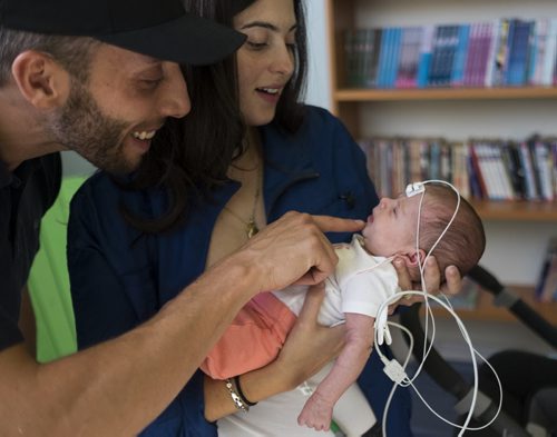 ZACHARY PRONG / WINNIPEG FREE PRESS  Anabela and Daniel Vicente with their daughter Camila before she receives a hearing screening at the Children's Hospital Research Institute of Manitoba on August 16, 2016. Starting on September 1, 2016, all newborns in Manitoba will receive the screening to detect any hearing problems at birth. Doing so will allow for early intervention that can help prevent or stop developmental problems arising from hearing loss.