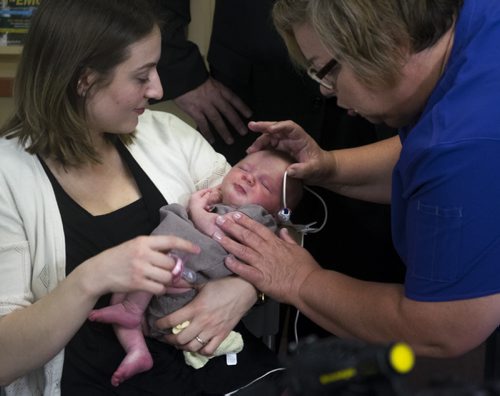 ZACHARY PRONG / WINNIPEG FREE PRESS  Nurse Gail Thompson performs a hearing screening on 4 week old Mabel at the Children's Hospital Research Institute of Manitoba as her mother Alana Shodine holds her on August 16, 2016. Starting on September 1, 2016, all newborns in Manitoba will receive the screening to detect any hearing problems at birth. Doing so will allow for early intervention that can help prevent or stop developmental problems arising from hearing loss.