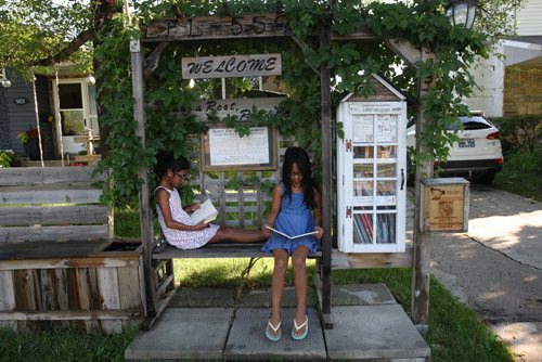 JOE BRYKSA / WINNIPEG FREE PRESS   Ella Sanchez, left,  and her sister Naina at the Little Free Library- 503 Gilmore - Aug 16, 2016 -(  See 49.8 Little Free Library story)