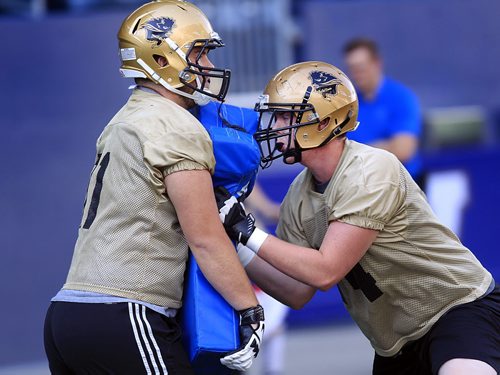 PHIL HOSSACK / WINNIPEG FREE PRESS - Bison offensive linemen #71 Tom Clarkson (left) and #74  Matt Clarkson drill at Investors Group Field Tuesday afternoon. See Jason Bell story.  August 16, 2016
