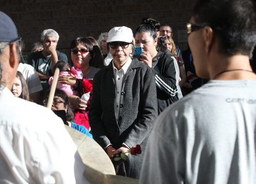 JOE BRYKSA / WINNIPEG FREE PRESS One of 18 survivors, Edna Jawbone, centre holds a rose at special apology ceremony to the Sayisi Dene people- Today at the Canadian Museum for Human Rights the Government of Canada apologized for the relocation of the Sayisi Dene from Little Duck Lake to North Knife River and Churchill in the 1950s and 1960s - Aug 17, 2016 -( See Ashleys story)