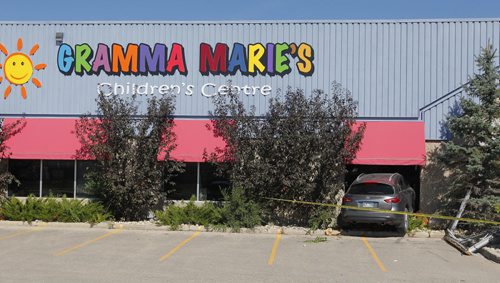 BORIS MINKEVICH / WINNIPEG FREE PRESS A grey/silver Infiniti SUV crashed through the front window of Gramma Marie's Children's Centre at 1461 Chevrier Blvd. before noon today. No other info on this scene. No emergency crews or police on scene when photog arrived. Yellow fire tape blocked off the area around the crash.  Intern reporter Alexandra De Pape is working on this story. August 17, 2016