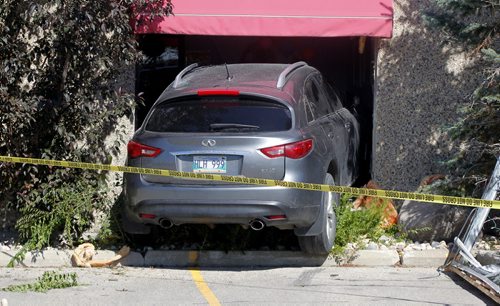 BORIS MINKEVICH / WINNIPEG FREE PRESS A grey/silver Infiniti SUV crashed through the front window of Gramma Marie's Children's Centre at 1461 Chevrier Blvd. before noon today. No other info on this scene. No emergency crews or police on scene when photog arrived. Yellow fire tape blocked off the area around the crash.  Intern reporter Alexandra De Pape is working on this story. August 17, 2016
