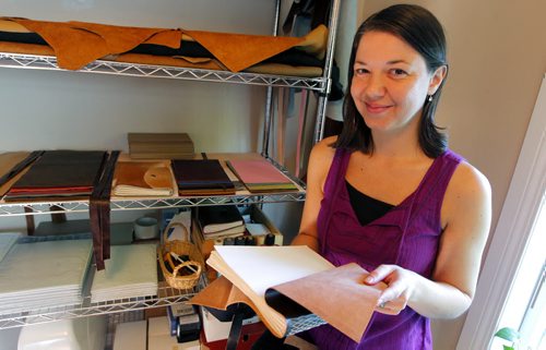 BORIS MINKEVICH / WINNIPEG FREE PRESS Andrea Davis has endometriosis which prevents her from working a regular 9-5 job. She started an Etsy company making hand-bound journals and notebooks that are ethically sourced. Her company is called We Are Bound Together. Here Davis poses with some of her finished product. For Erin Lebar story. August 17, 2016