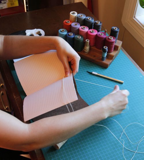 BORIS MINKEVICH / WINNIPEG FREE PRESS Andrea Davis has endometriosis which prevents her from working a regular 9-5 job. She started an Etsy company making hand-bound journals and notebooks that are ethically sourced. Her company is called We Are Bound Together. Detail shot of Davis working on a journal binding. For Erin Lebar story. August 17, 2016