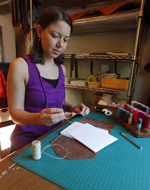 BORIS MINKEVICH / WINNIPEG FREE PRESS Andrea Davis has endometriosis which prevents her from working a regular 9-5 job. She started an Etsy company making hand-bound journals and notebooks that are ethically sourced. Her company is called We Are Bound Together. In this photo Davis works on some of her creations. For Erin Lebar story. August 17, 2016