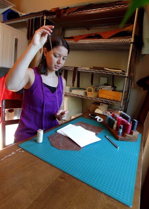BORIS MINKEVICH / WINNIPEG FREE PRESS Andrea Davis has endometriosis which prevents her from working a regular 9-5 job. She started an Etsy company making hand-bound journals and notebooks that are ethically sourced. Her company is called We Are Bound Together. In this photo Davis works on some of her creations. For Erin Lebar story. August 17, 2016