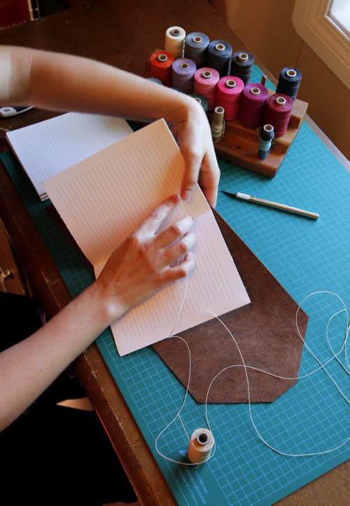 BORIS MINKEVICH / WINNIPEG FREE PRESS Andrea Davis has endometriosis which prevents her from working a regular 9-5 job. She started an Etsy company making hand-bound journals and notebooks that are ethically sourced. Her company is called We Are Bound Together. Detail shot of Davis working on a journal binding. For Erin Lebar story. August 17, 2016