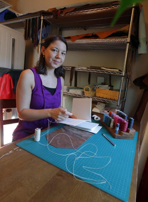 BORIS MINKEVICH / WINNIPEG FREE PRESS Andrea Davis has endometriosis which prevents her from working a regular 9-5 job. She started an Etsy company making hand-bound journals and notebooks that are ethically sourced. Her company is called We Are Bound Together. In this photo Davis poses for a portrait while she  works on some of her creations. For Erin Lebar story. August 17, 2016