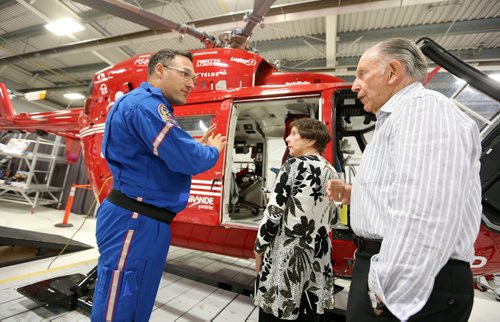 JASON HALSTEAD / WINNIPEG FREE PRESS  L-R: Shock Trauma Air Rescue Society (STARS) base director Grant Therrien gives attendees Sondra Rice and  Morley Bernstein a tour of the helicopter at a fundraising dinner for STARS on Aug. 17, 2016, at the STARS hangar. STARS is a non-profit helicopter air ambulance organization that provides rapid and specialized emergency care and transportation for critically ill and injured patients. (See Social Page)
