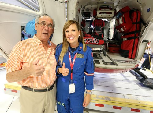 JASON HALSTEAD / WINNIPEG FREE PRESS  Shock Trauma Air Rescue Society (STARS) flight nurse Sarah Painter (right) shows the helicopter to guest Archie Cham at a fundraising dinner for STARS on Aug. 17, 2016, at the STARS hangar. STARS is a non-profit helicopter air ambulance organization that provides rapid and specialized emergency care and transportation for critically ill and injured patients. (See Social Page)