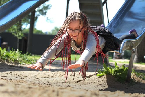 RUTH BONNEVILLE  / WINNIPEG FREE PRESS  Nine-year-old Sophia Seniuk reaches out her hands to catch her fall while playing on the slide with her siblings at Kildonan Park Thursday.    Standup photo   Aug 17 / 2016