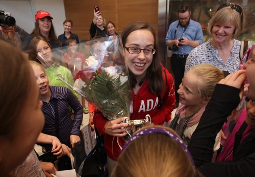 JOE BRYKSA / WINNIPEG FREE PRESS  Brandon, Manitoba gymnast Isabela Onyshko gets swarmed by family and fellow athletes as she arrives home from the Olympics in Brazil at Richardson International Airport friday morning - Aug 19, 2016 -(  Breaking News)