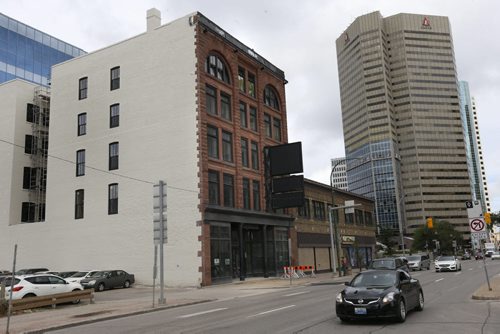 WAYNE GLOWACKI / WINNIPEG FREE PRESS   The historic building,left, at 272 Main St. (former IKON Solutions building two doors south of Graham, on the west side of Main).  Work is finally underway to convert the former office building into micro apartments.  Murray McNeill  August 19 2016
