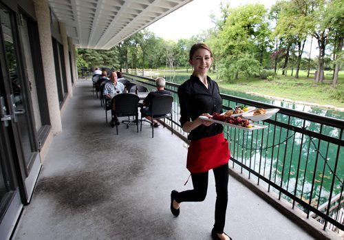RUTH BONNEVILLE  / WINNIPEG FREE PRESS  Restaurant Review - Prairie's Edge, pavilion at Kildonan Park server, Ashley Pidwerbesky serves up Arctic Char Salad, beet fritters and Smoked Manitoba Goldeye Pasta dish on picturesque patio overlooking pond.     Aug 19 / 2016