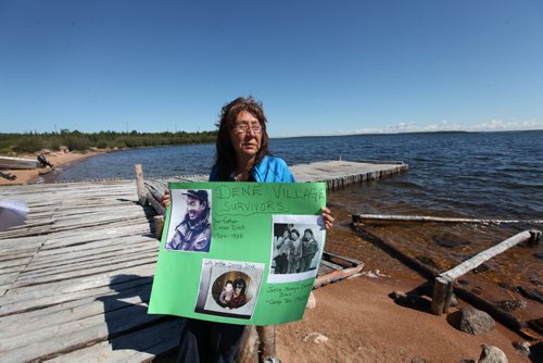 RUTH BONNEVILLE  / WINNIPEG FREE PRESS  Nancy Powderhorn sits on the shores of Tadoule Lake Tuesday holding a picture of her when she was a young girl in Duck Lake where she lived before the forced relocation of the Dene people to a community near Churchill.  Minister Carolyn Bennett made a formal apology to the Dene People in Tadoule Lake Tuesday which includes financial settlement.  See Alex Paul story.    Aug 16 / 2016