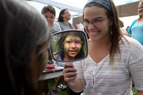 RUTH BONNEVILLE  / WINNIPEG FREE PRESS  Nine-year-old Leah Richard checks out her butterfly painted on her face by face painting artist Carolyn Zacharias at the 7th Annual North End Family Centre BBQ at Champlain School Saturday.    Aug 19 / 2016
