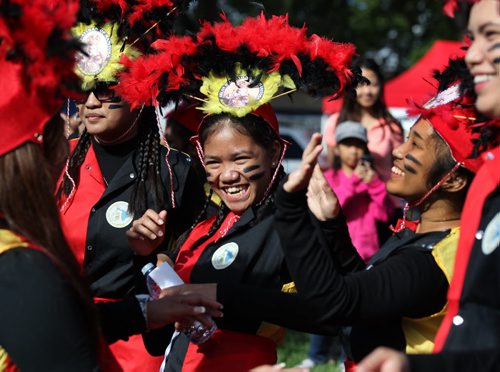 RUTH BONNEVILLE  / WINNIPEG FREE PRESS  Gwyneth Arsenio (centre) laughs with fellow members of Aklan Ati-Atihan of Manitoba as they dance on Broadway during the 5th annual Manitoba Filipino Street Festival Saturday.   Aug 19 / 2016