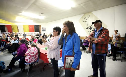 RUTH BONNEVILLE  / WINNIPEG FREE PRESS  Nancy Powderhorn of Tadoule Lake gets emotional while Minister Carolyn Bennett made a formal apology in Tadoule Lake on behalf of the Government of Canada for a forced relocation of Dene people.  She holds a picture of herself and family taken 60 years ago in Little Duck Lake before they were forced to leave.   See Alex Paul story.    Aug 16 / 2016