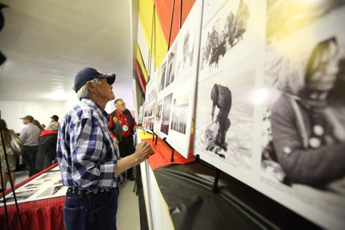 RUTH BONNEVILLE / WINNIPEG FREE PRESS   Thomas Duck one of the 18 Sayisis Dene survivors from Little Duck Lake  looks at photographs on display in hall in Tadoule Lake.   Minister Carolyn Bennett made a formal apology to the residents of Tadoule Lake for the forced relocation of the Dene people at formal ceremony on Tuesday.    See Alex Paul story.   Aug 16 / 2016