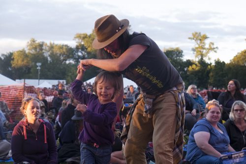 ZACHARY PRONG / WINNIPEG FREE PRESS  David Wright dances with his daughter Winnie during a live steam of the Tragically Hip Concert at Asssinboine Park. August 20, 2016.