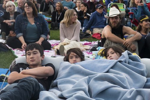 ZACHARY PRONG / WINNIPEG FREE PRESS  Tanner Ritchot, from left, Phoenix Crystoval and Brooke Ritchot watch a live stream of the Tragically Hip's final concert at Assiniboine Park. August 20, 2016.