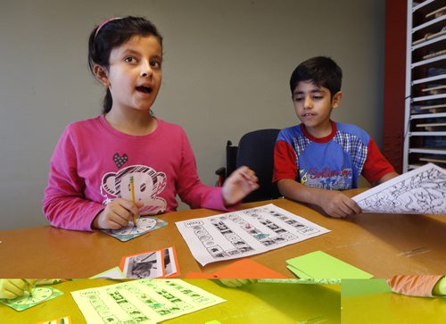 WAYNE GLOWACKI / WINNIPEG FREE PRESS   At right, Ahmed El Ahmar and Duaa Almaslmani play a game identifying pictures with english words during the Living English program, a summertime English language classes for parents and kids at the downtown RRC campus.Carol Sanders story  August 22 2016
