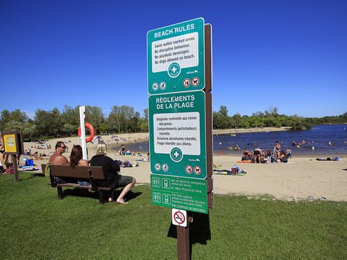 PHIL HOSSACK / WINNIPEG FREE PRESS -   A sign with safety rules stands guard in lieu of lifeguards while Beachgoers enjoy the water at St Malo Provincial Park Monday afternoon. See story. August 22, 2016