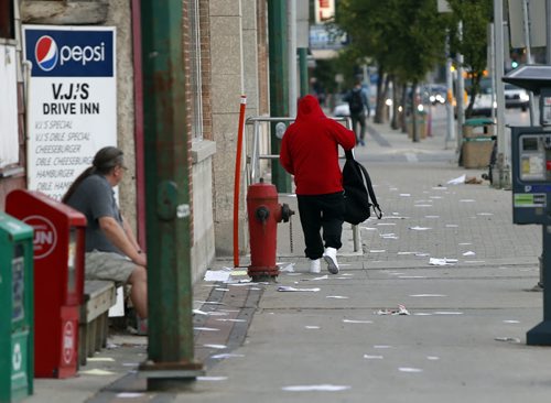 WAYNE GLOWACKI / WINNIPEG FREE PRESS    A lawyer's paperwork litters the westside of the sidewalk along Main Street  just north of Broadway Tuesday morning. August 23 2016