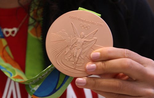 JOE BRYKSA / WINNIPEG FREE PRESS  Team Canadas Desiree Scott / soccer shows off her bronze medal as she arrives home at Richardson International Airport tuesday morning from the Olympics in Rio - Aug 23, 2016