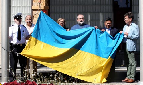 JOE BRYKSA / WINNIPEG FREE PRESS L to R - Commissionaire Phil Durward, Ostap Skrypnyk, and Oksana Bondarcuk of the Ukrainian Canadian Congress, Father Taras Udod, Deputy Mayor Mike Pagtakhan, and Councilor Brian Mayes- St Vital  with the Ukrainian flag  that was raised at City Hall by the Winnipeg's Ukrainian Canadian Community that marked  the 25th Anniversary of Ukrainian Independence Day- A gathering will also take place this eve to mark the event at Kildonan Park-Aug 24, 2016 -(  Standup Photo)